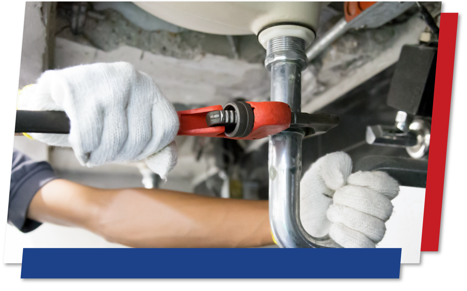 Closeup of a plumber repairing a pipe underneath a sink.